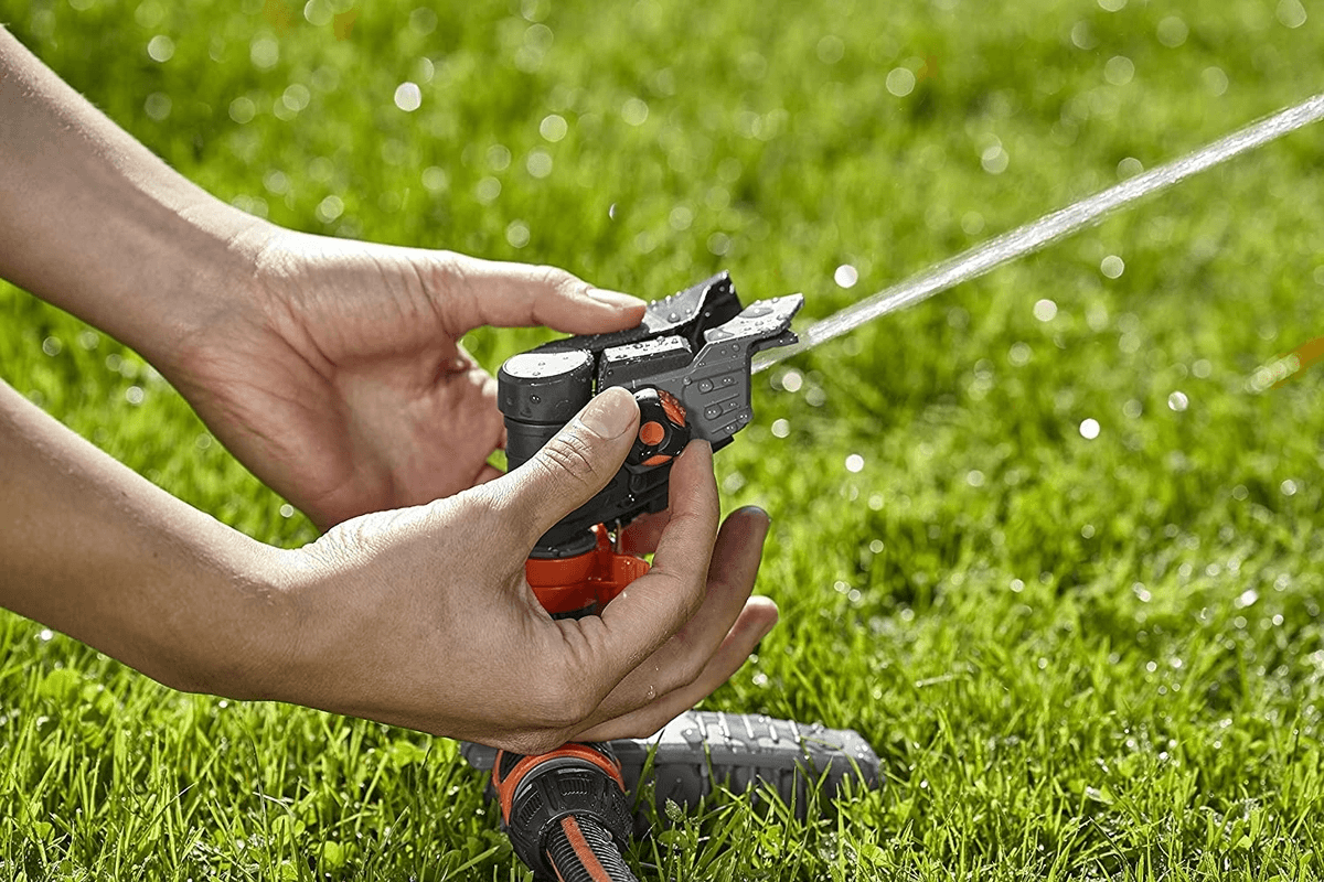 Comfort-Full-or-Part-Circle-Pulse-Sprinkler-Spike-man-adjusting-sprinkler.png