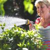 HOZELOCK-Multi-Spray-Watering-Hose-Gun-woman-watering-bushes.jpg