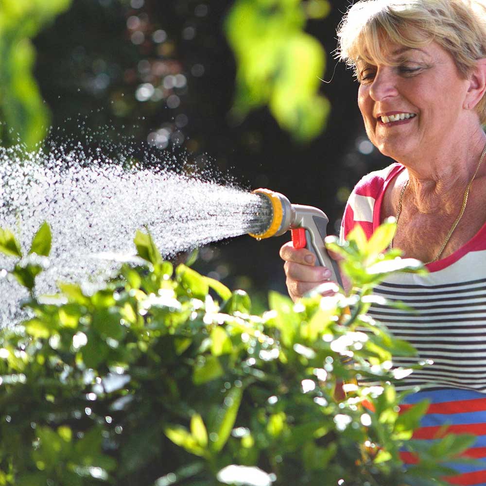 HOZELOCK-Multi-Spray-Watering-Hose-Gun-woman-watering-bushes.jpg
